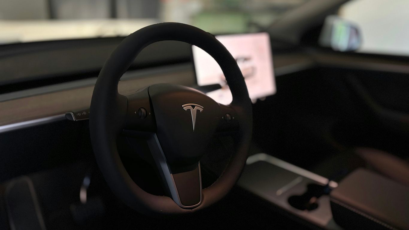 A tesla's steering wheel and interior.