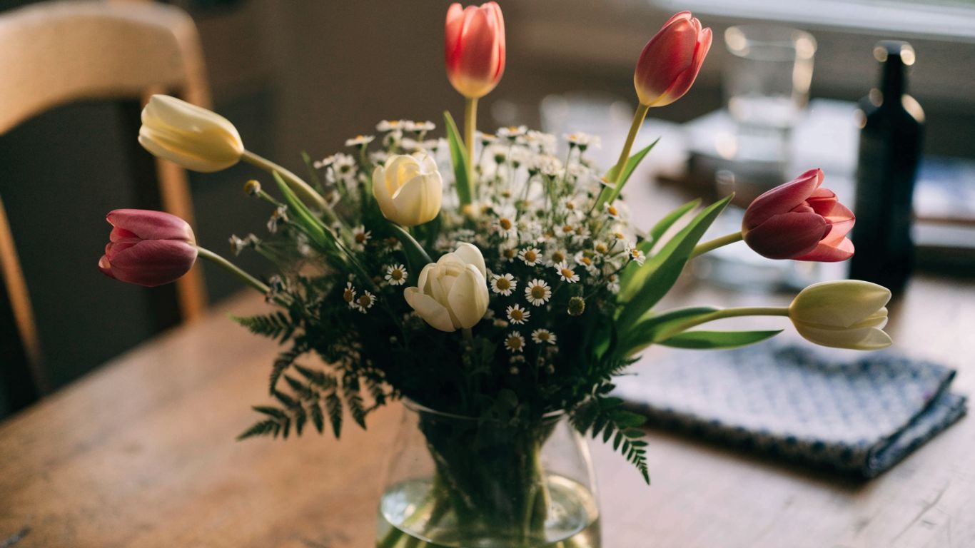Seasonal flowers arranged in a simple glass vase