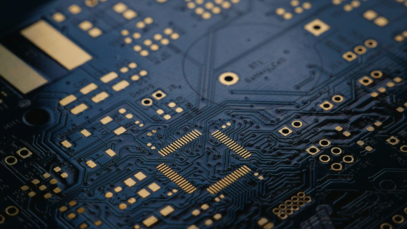 A circuit board background representing quantum computational architecture