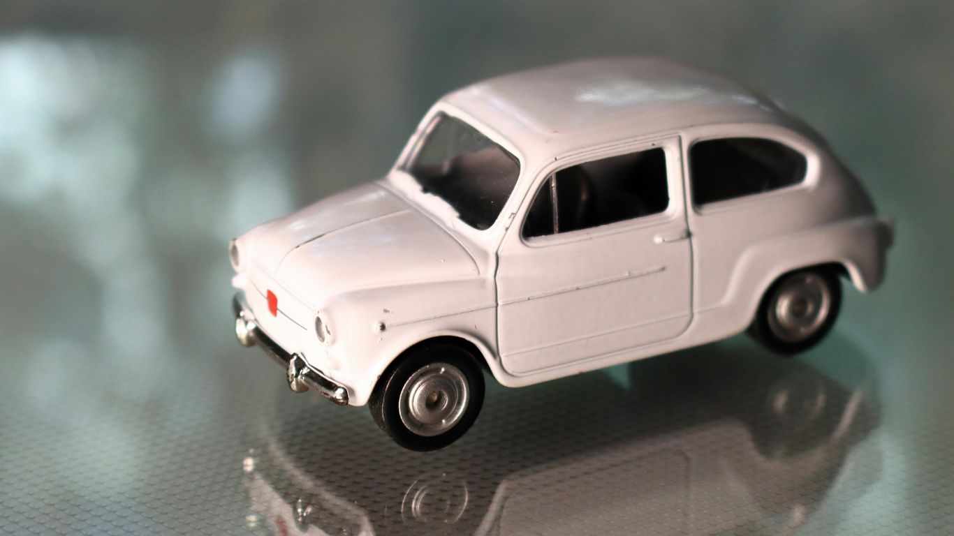 a white toy car sitting on top of a table