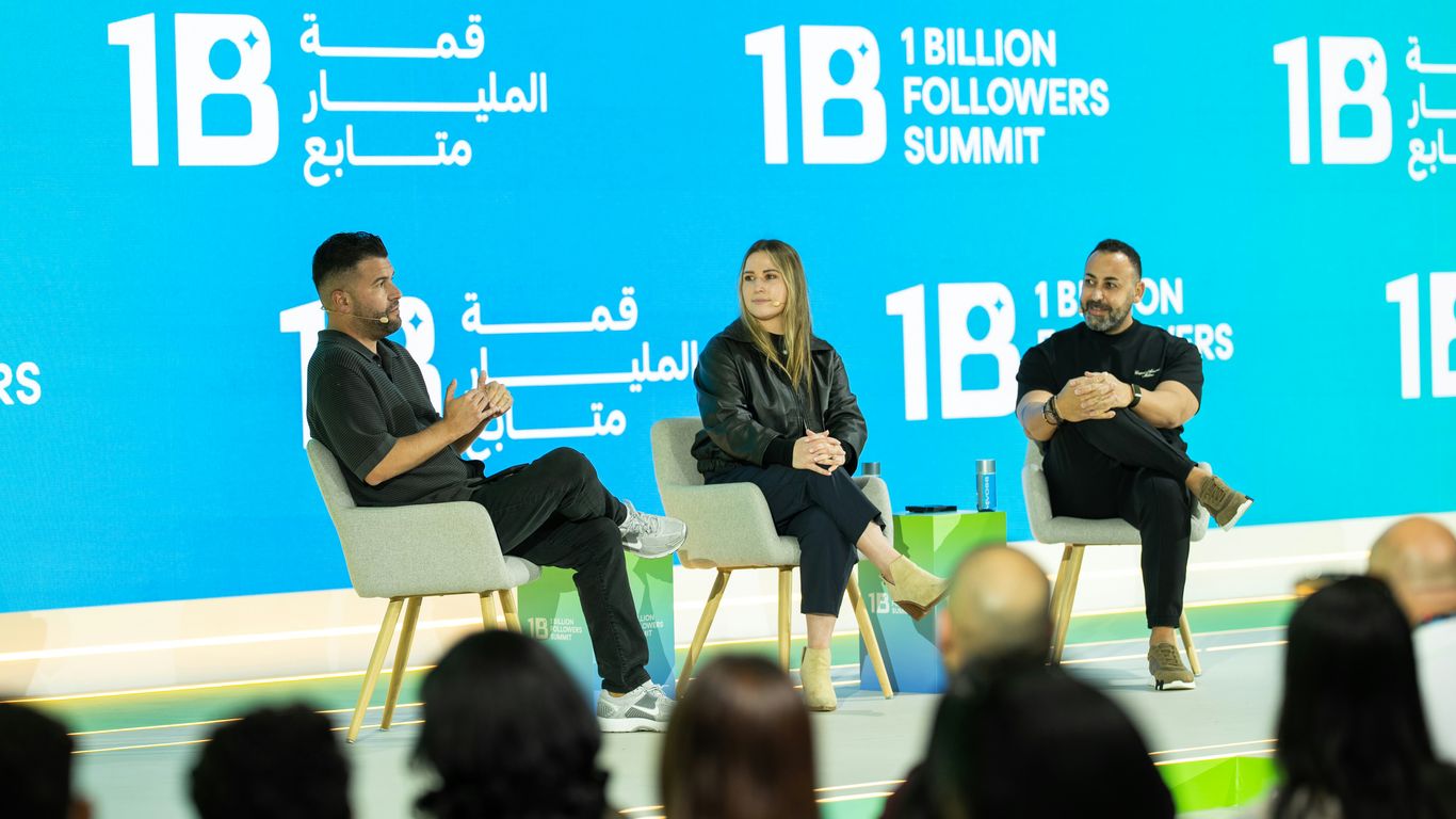 Three people on stage at a summit