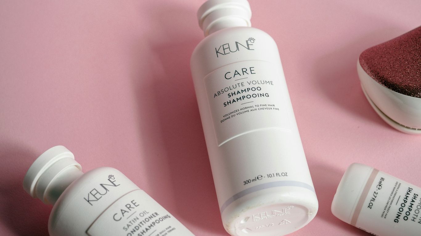 a bottle of keune care next to some other products