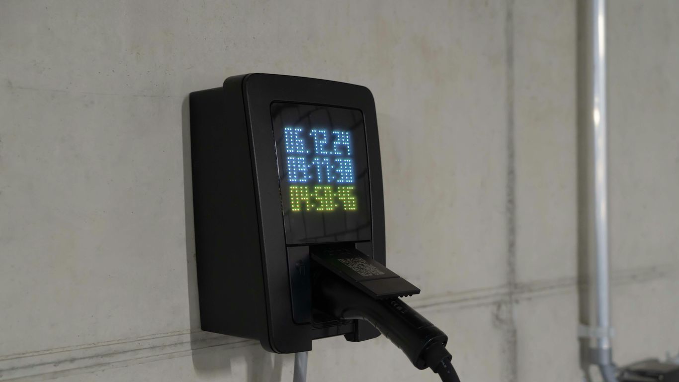 Electric car charger on a concrete wall