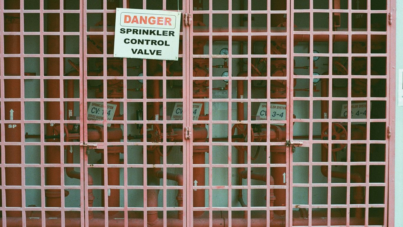 brown metal gate with white and black sign