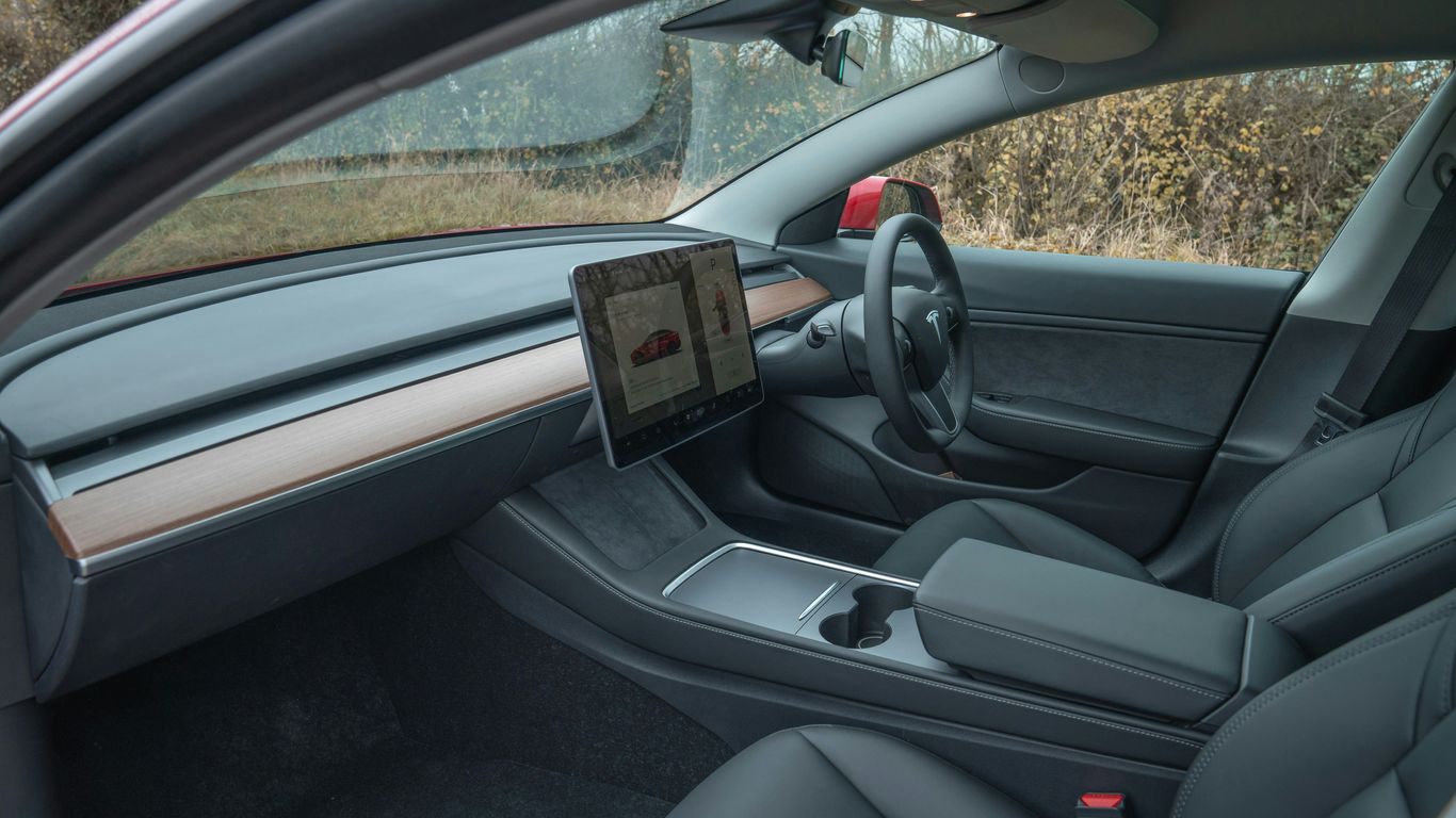 Interior view of a modern car with a large touchscreen.
