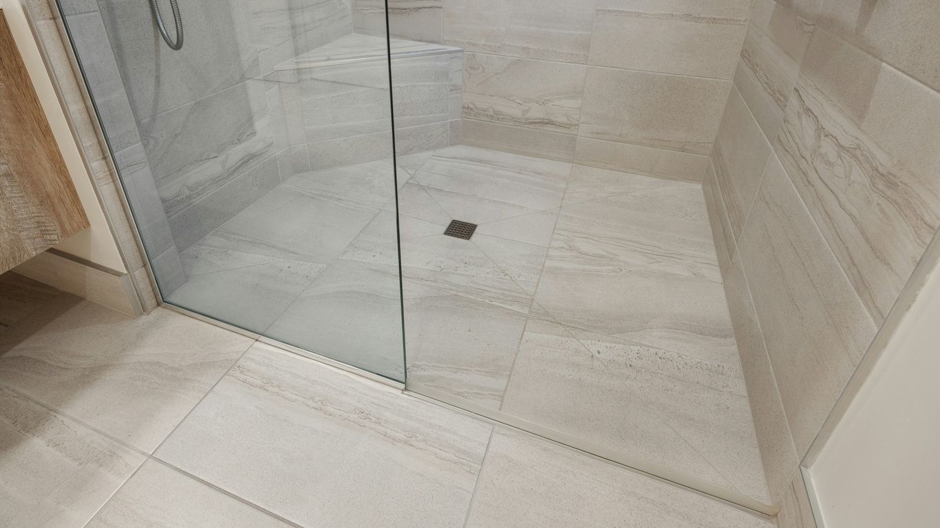 Stone bathtub footprint on tiled floor