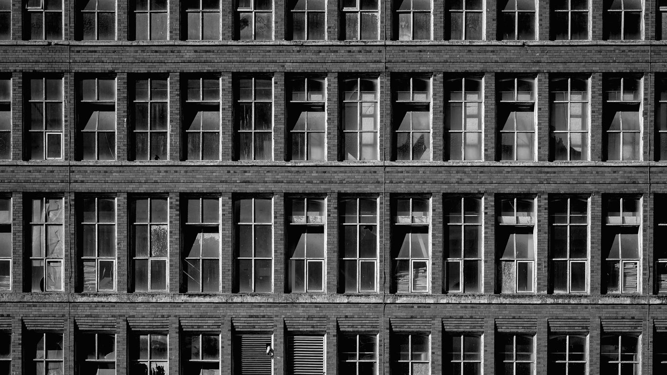 Rows of windows on a brick building exterior.