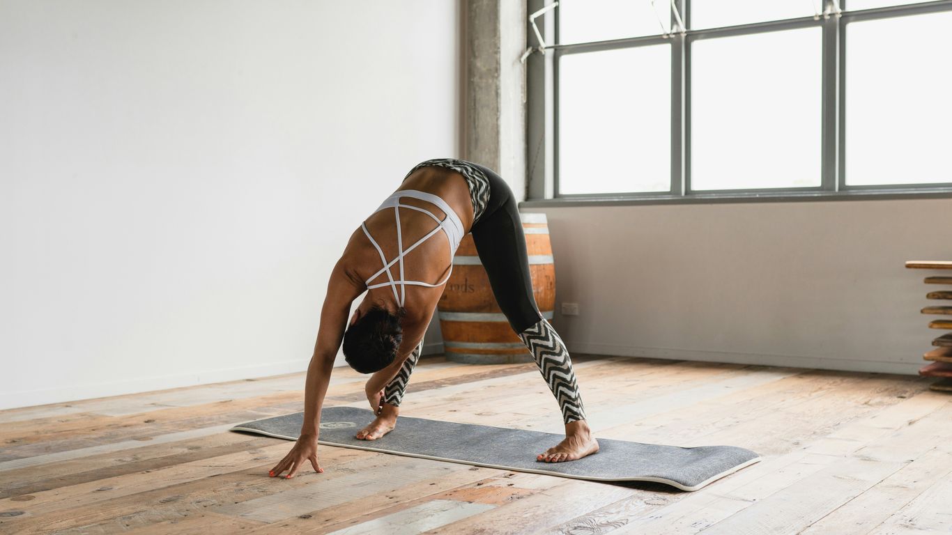 Yoga practitioner using strap for shoulder mobility