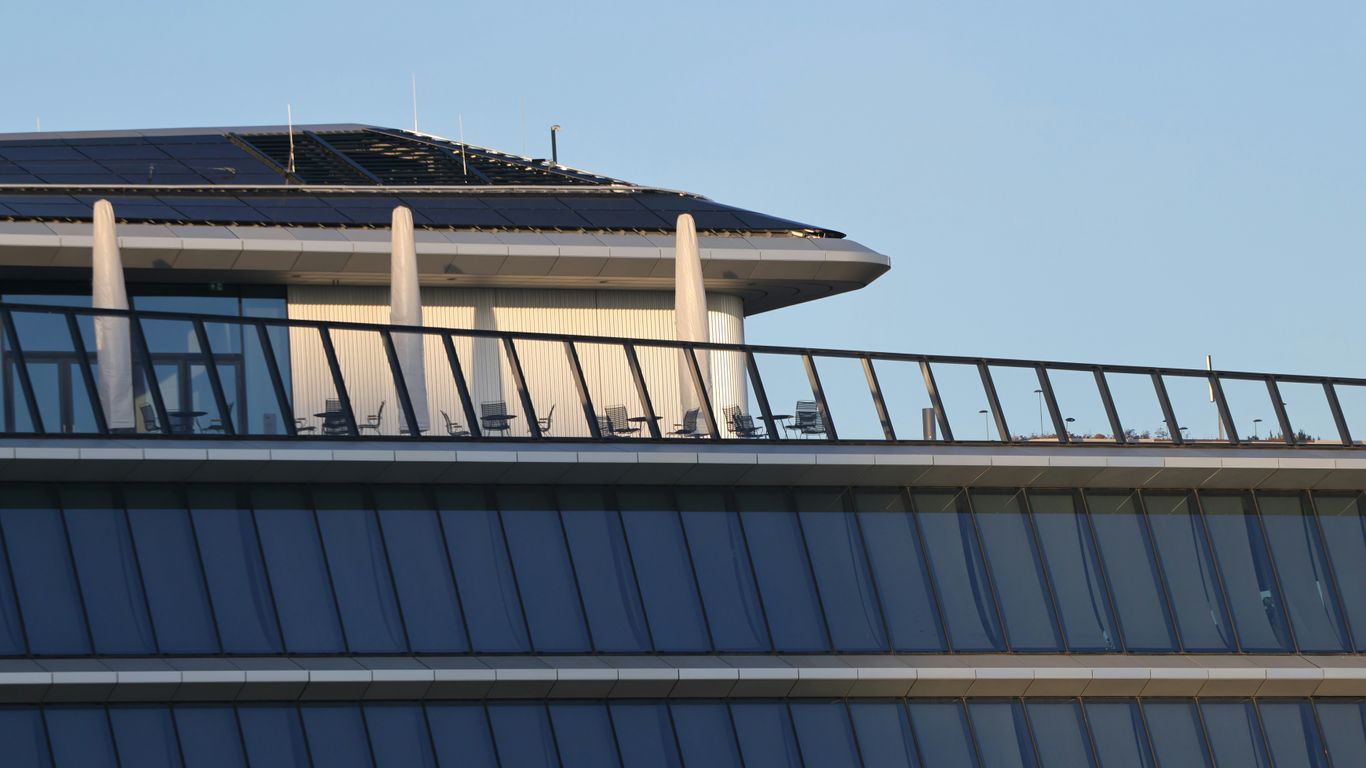 An airplane is flying over a building