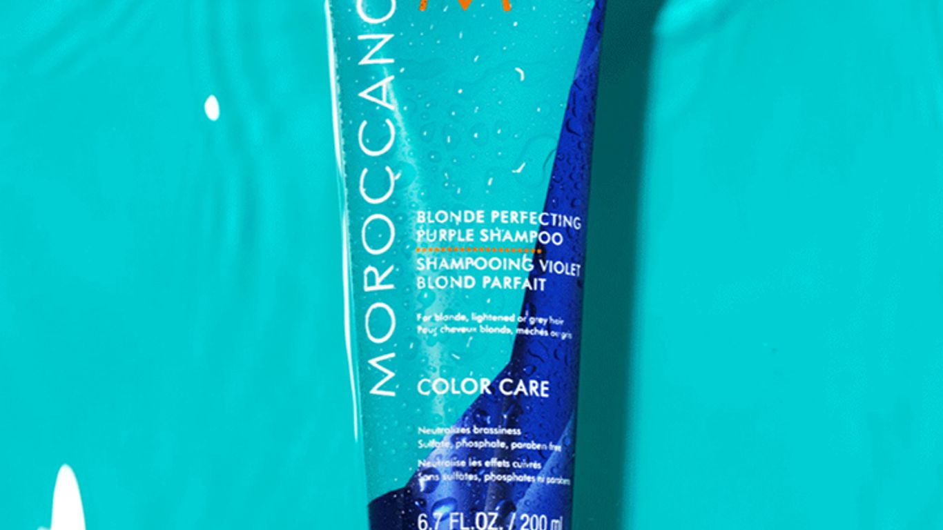 Moroccanoil shampoo bottle floating in water, hair care product.