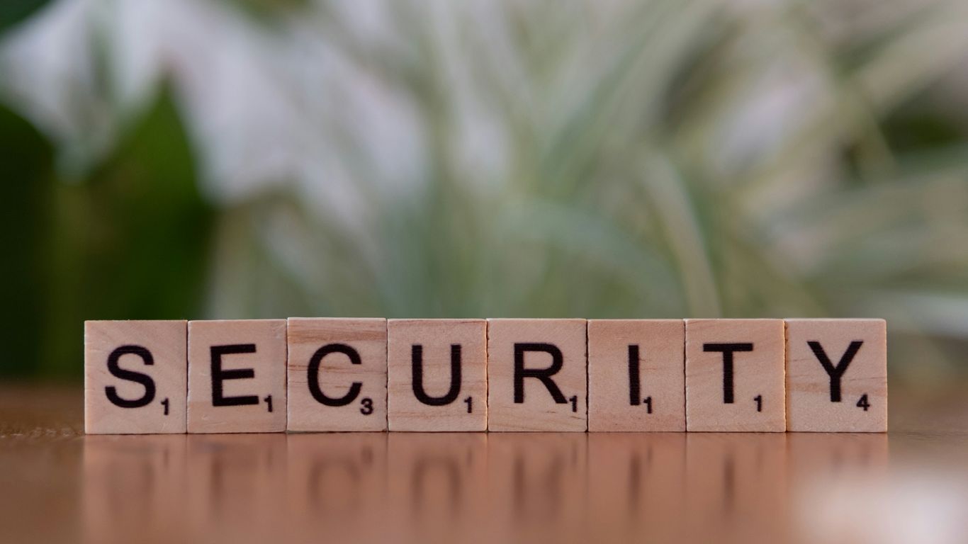A wooden block spelling security on a table