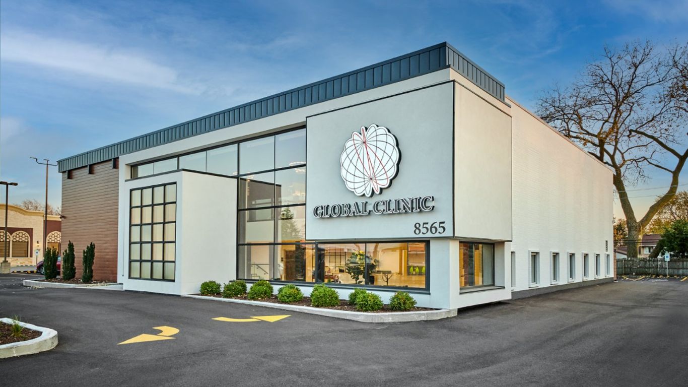 Modern Global Clinic building with large windows and a logo.