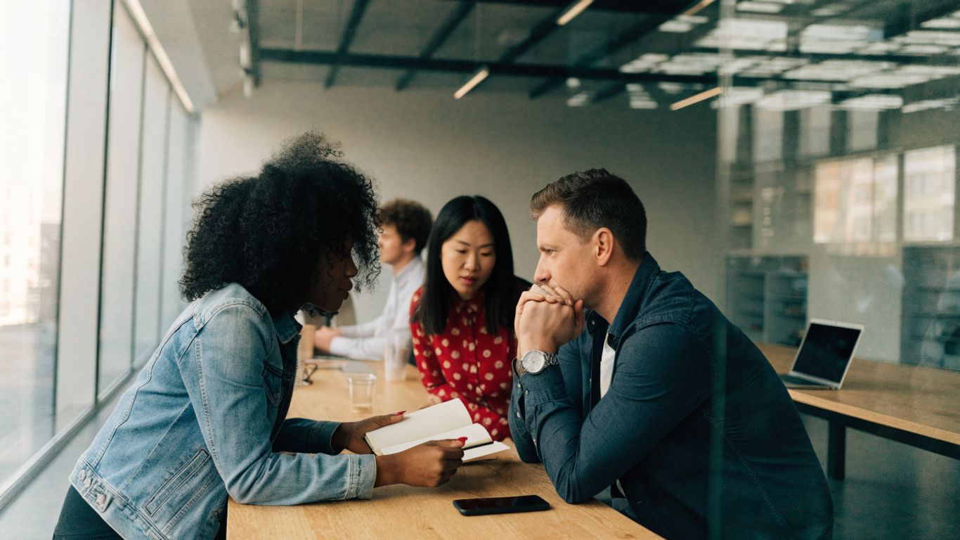 Manager preparing a team for a video meeting