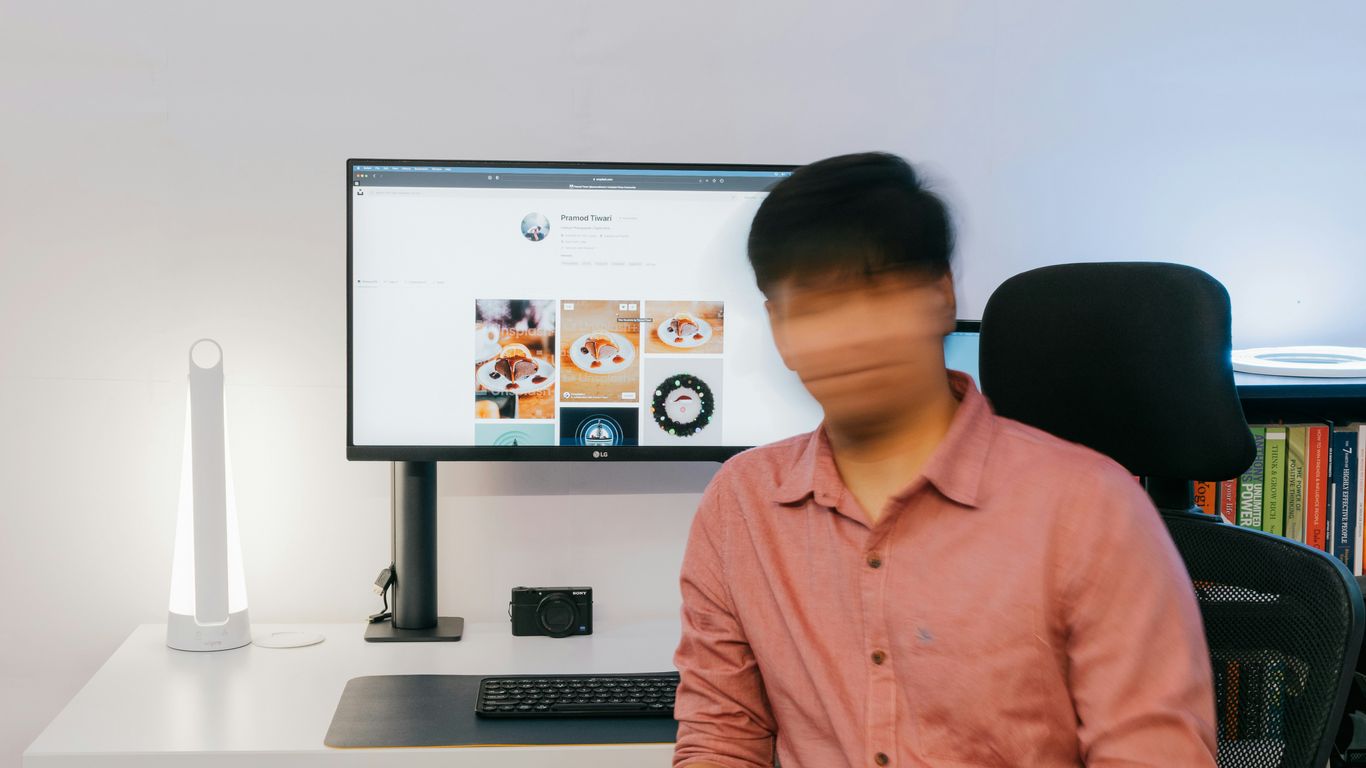 a person sitting in front of a computer