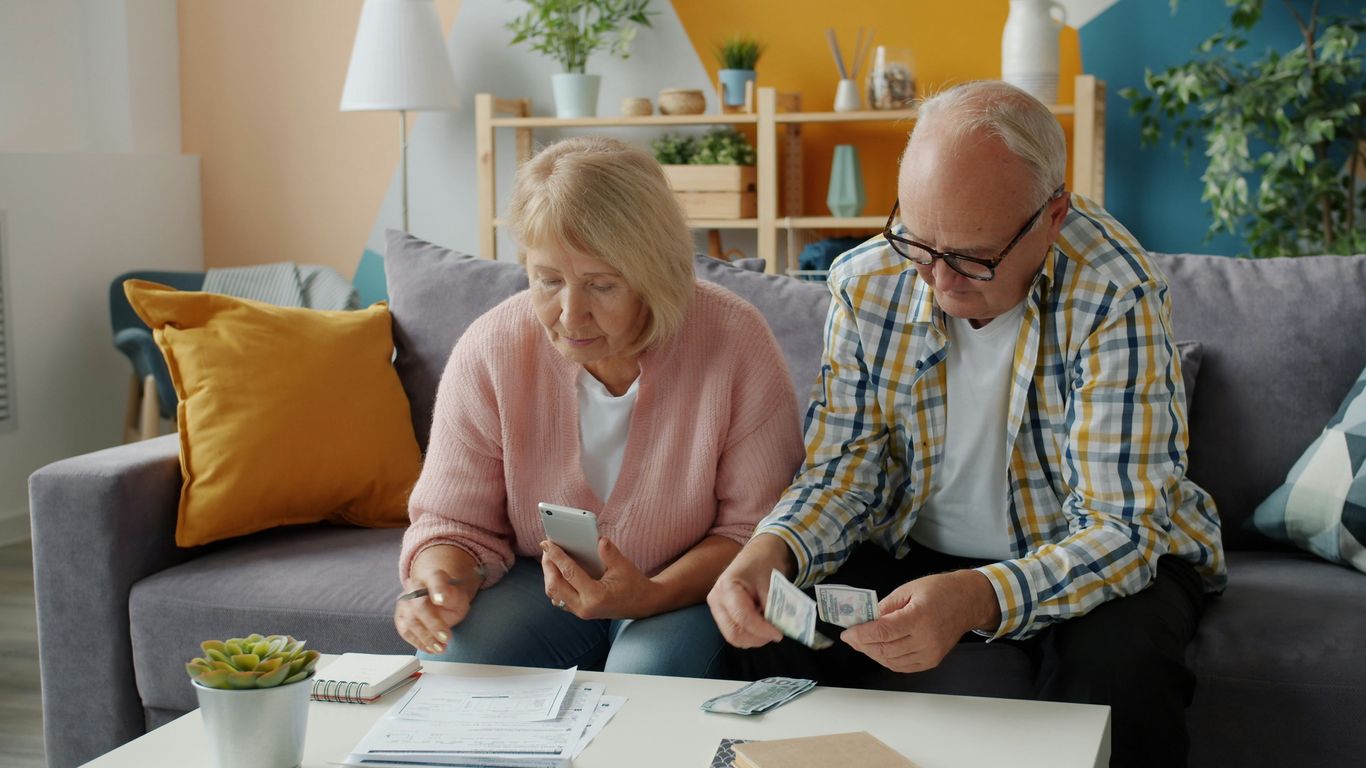 Elderly couple managing finances at home