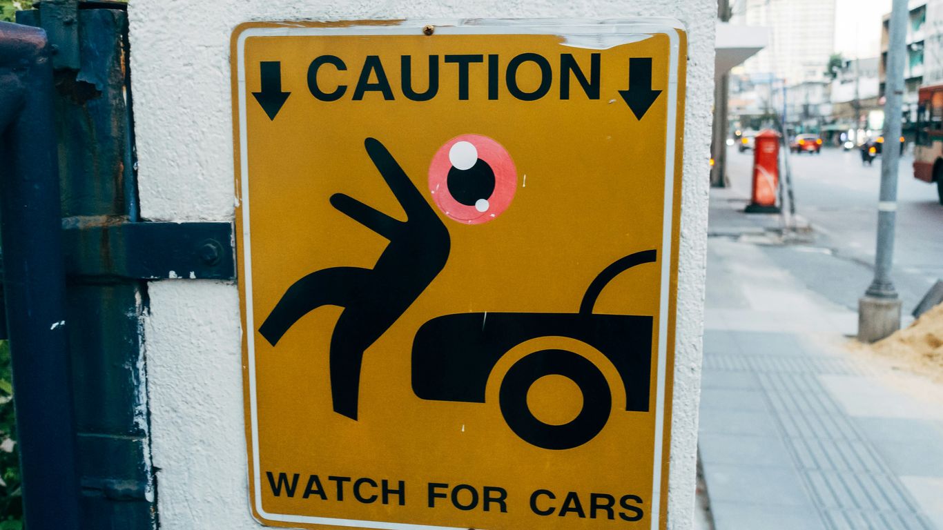 a caution sign on the side of a building
