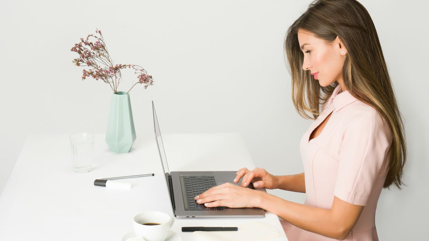 woman sitting while using laptop