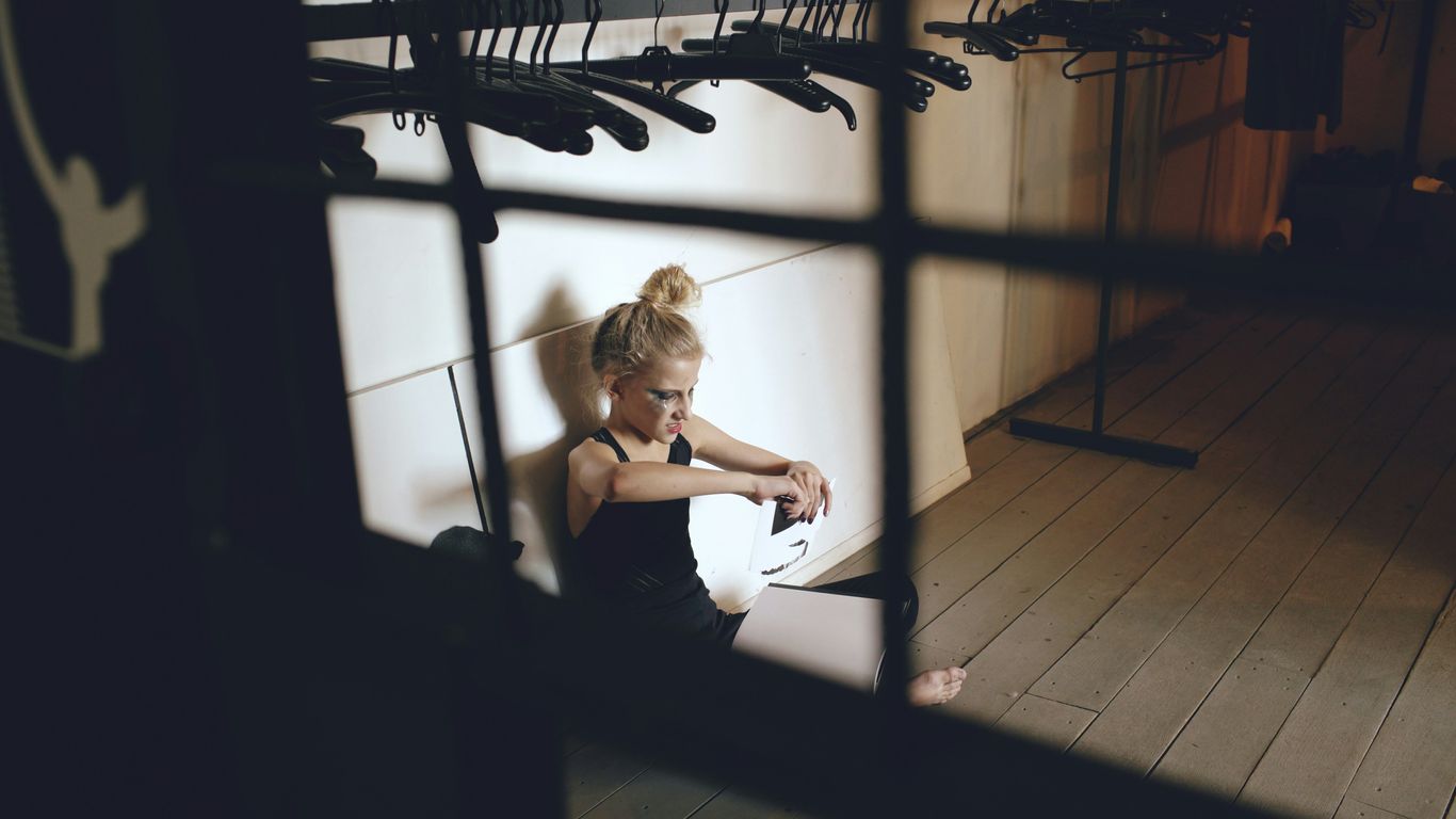 Woman sitting on floor with guitar