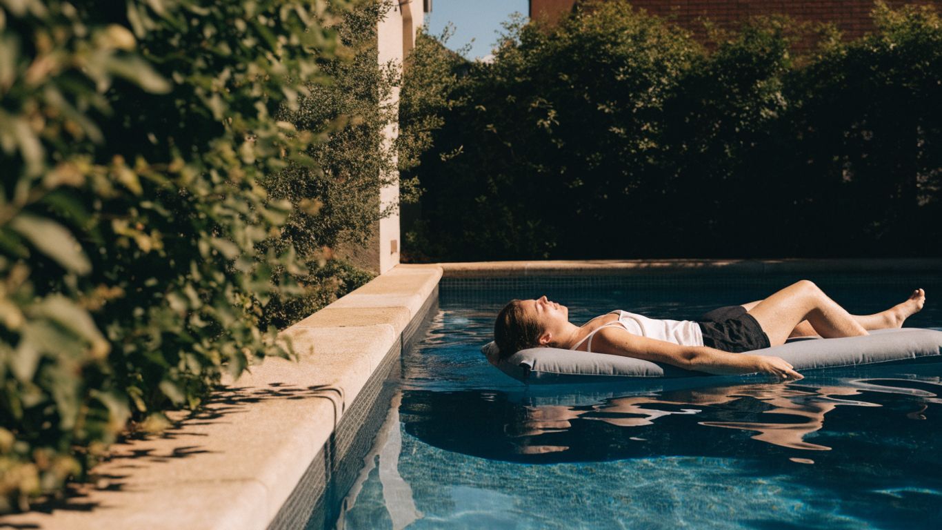 Adult floating comfortably in a spacious backyard pool