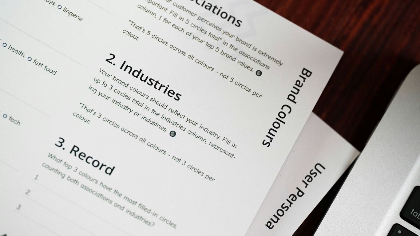 a computer keyboard sitting on top of a wooden table