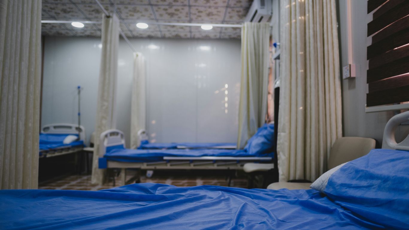 blue bed linen near white window curtain