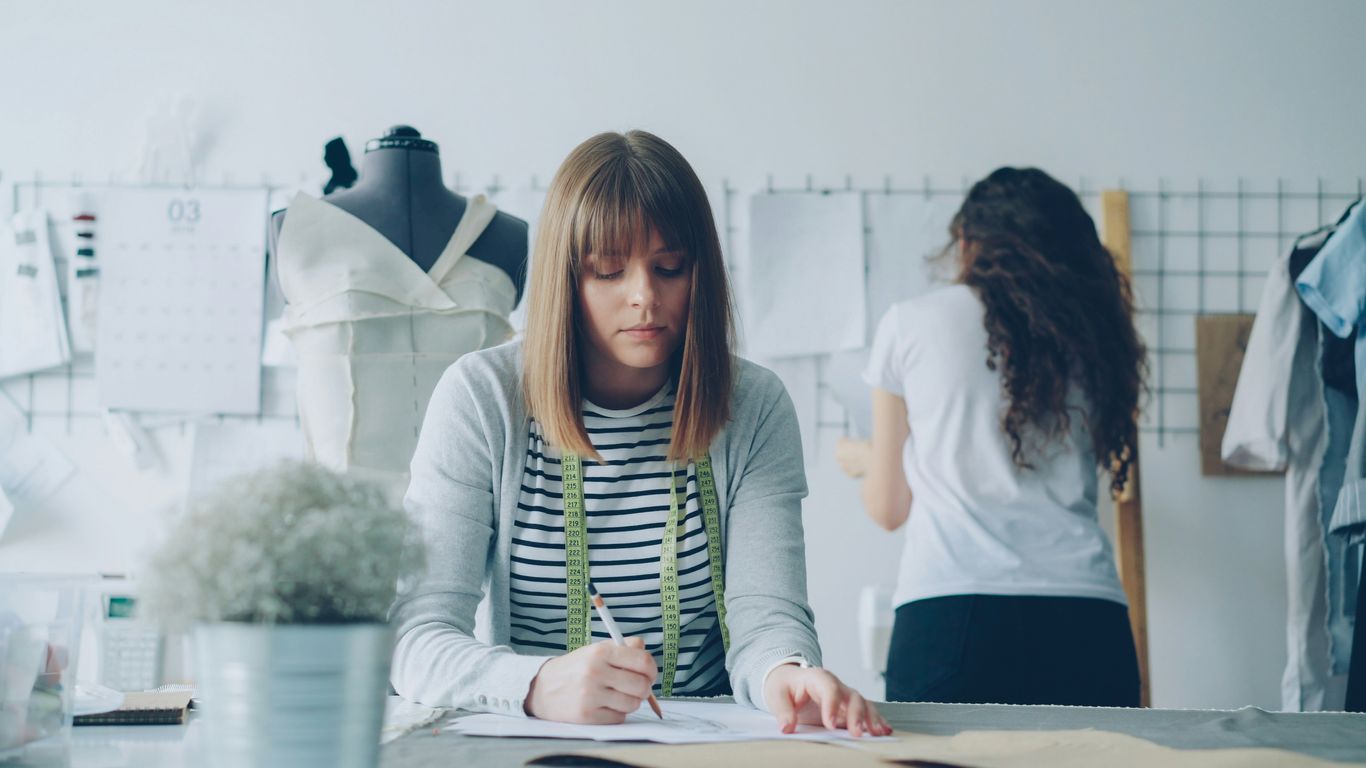 Fashion designers work in a workshop.