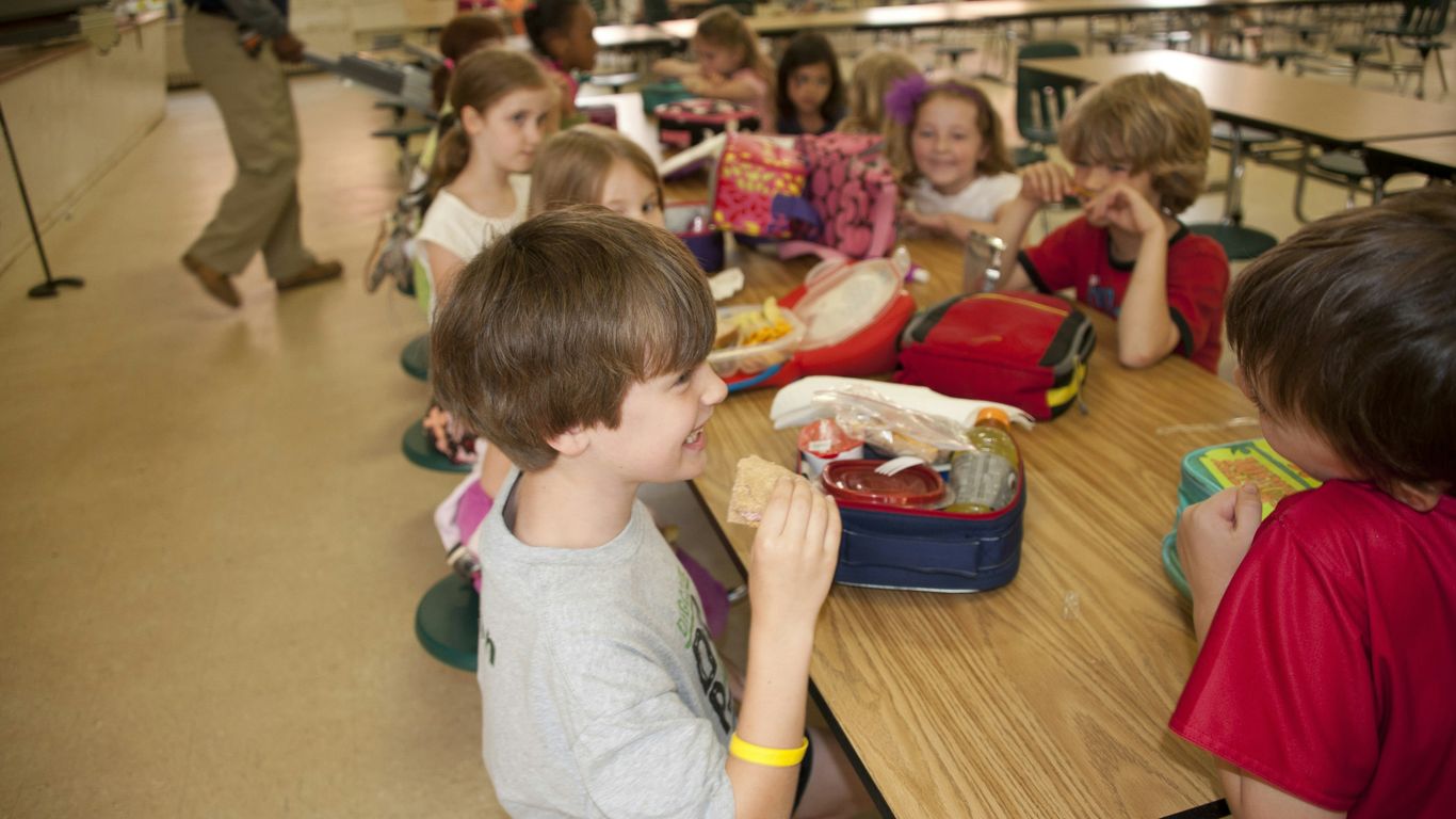 boy in gray crew neck t-shirt eating