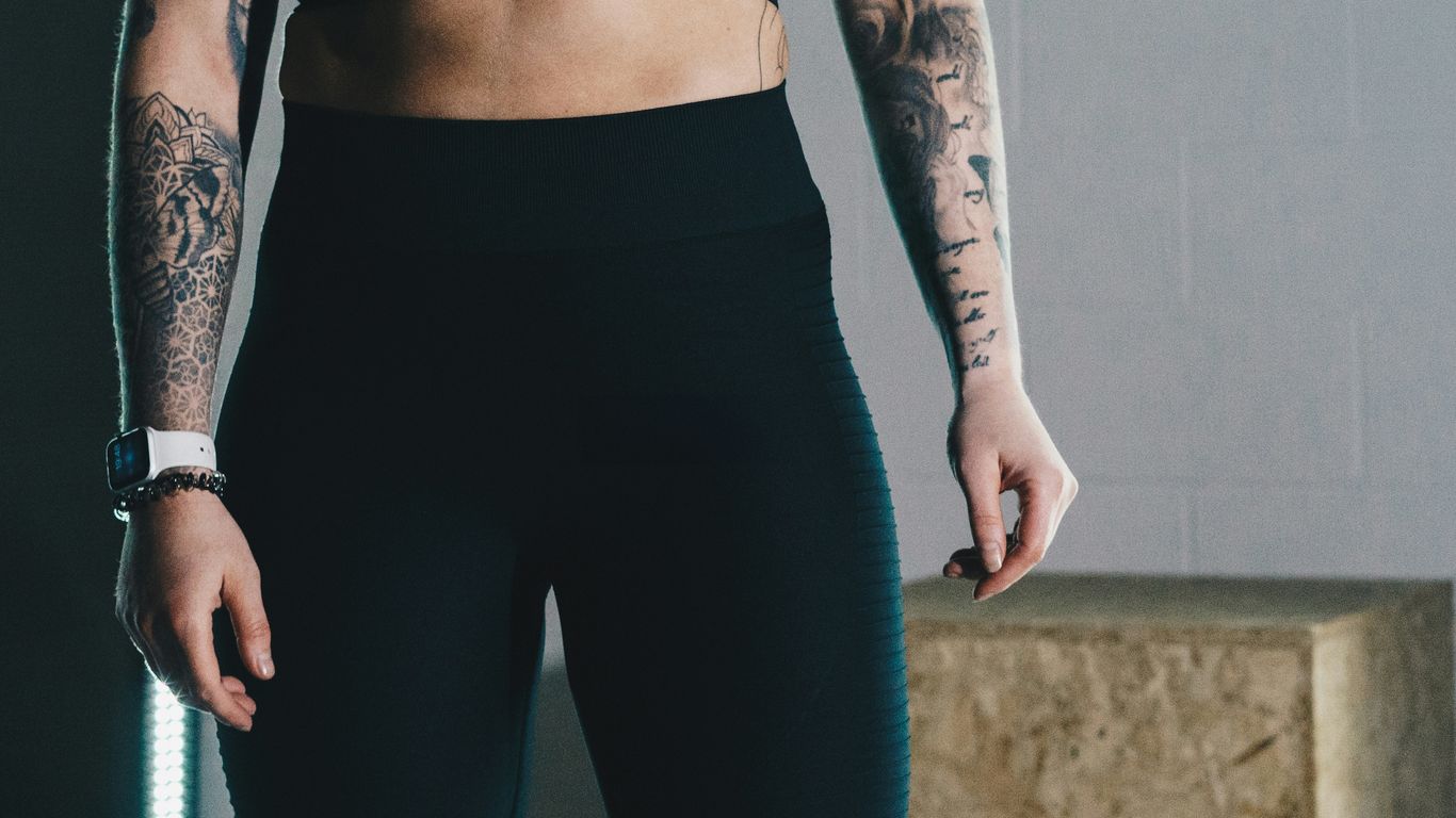 a woman in a black sports bra top and leggings