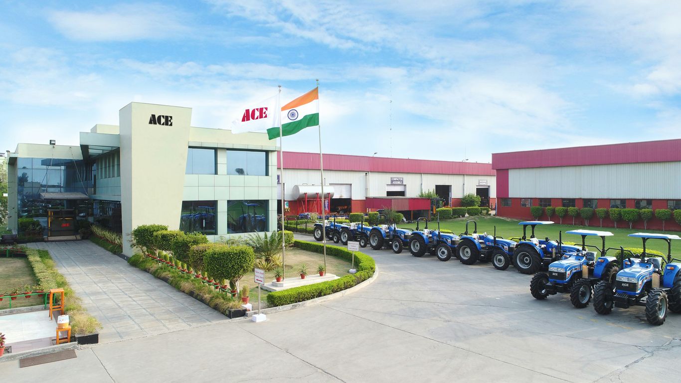 blue and black tractors parking near building