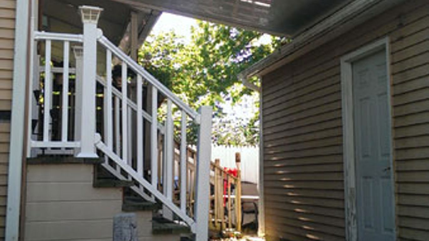 Arkel Products awning over a deck and walkway.