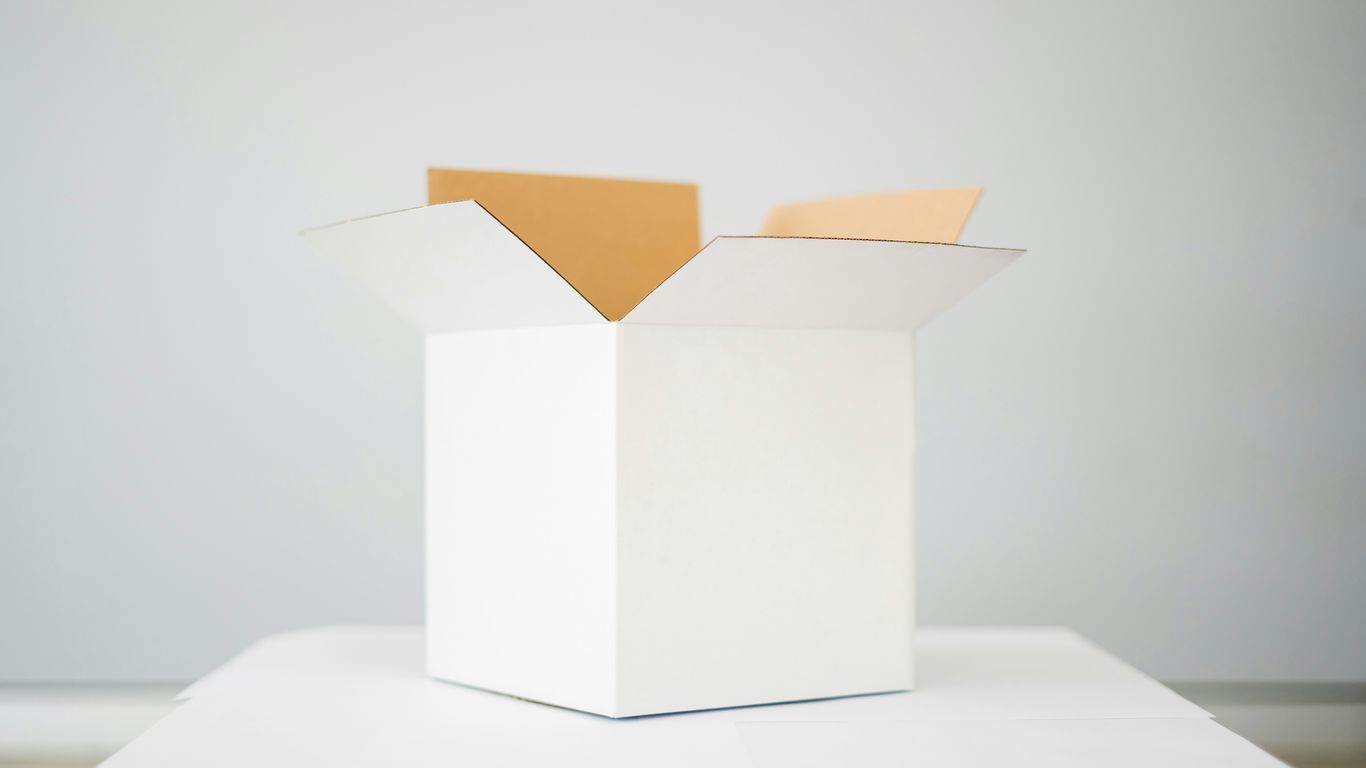 Export paperwork beside packed cartons