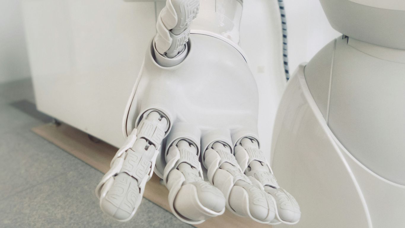 A futuristic humanoid robot working in an office