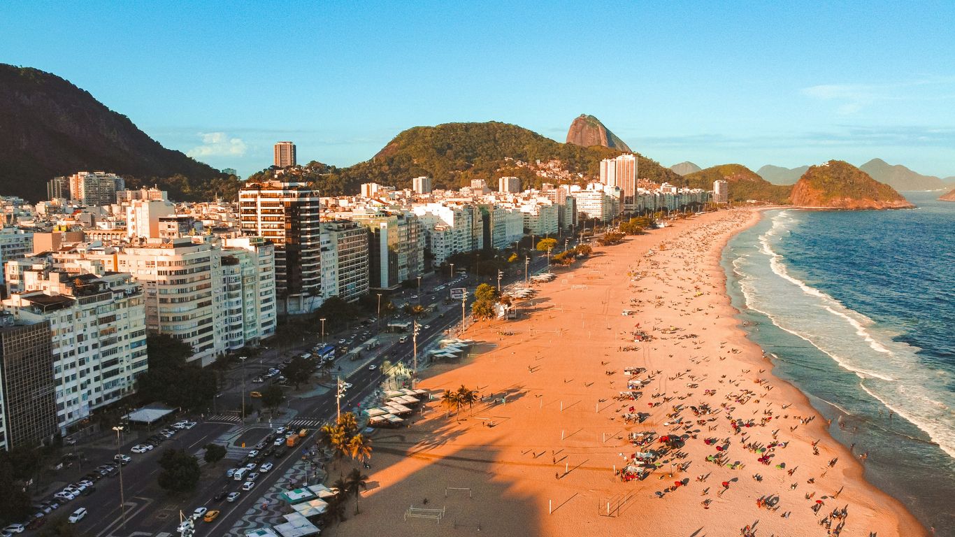 an aerial view of a beach with a city in the background