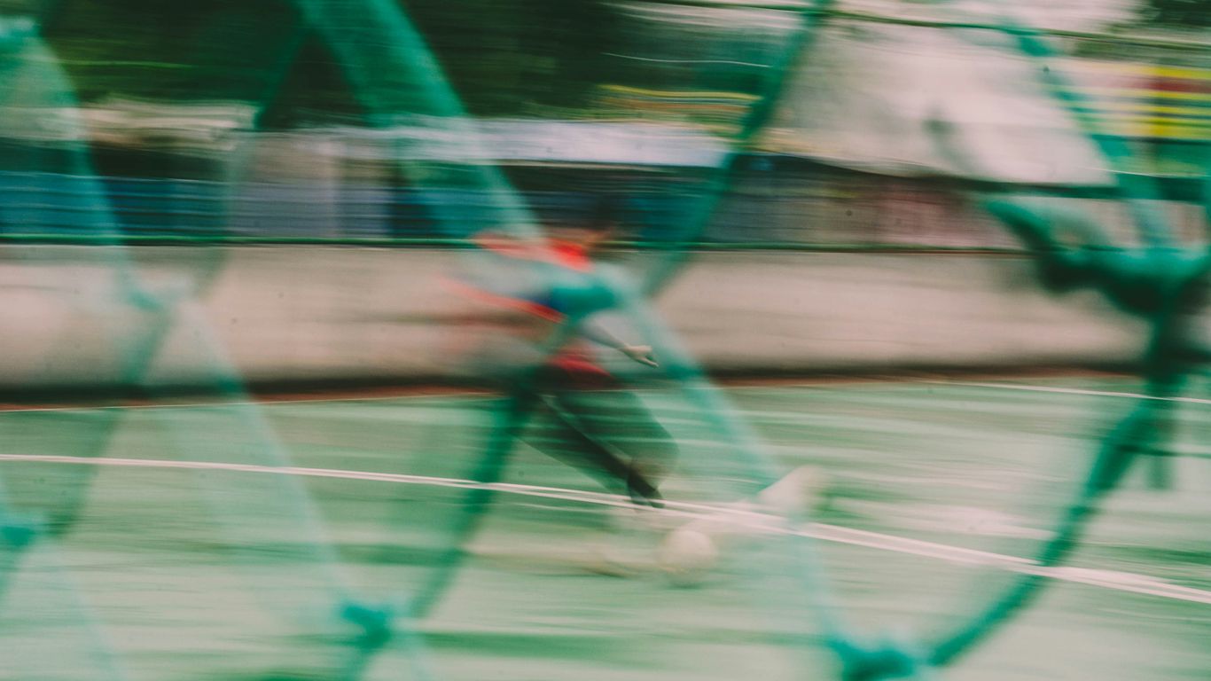 person in blue shorts riding on brown horse