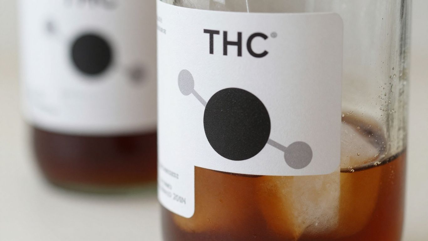 THC cold brew bottle with subtle molecule graphic