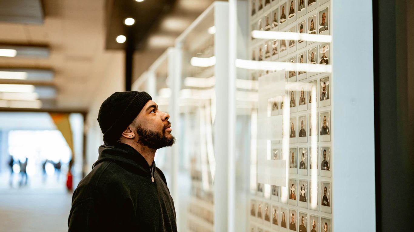 A man standing in front of a white wall