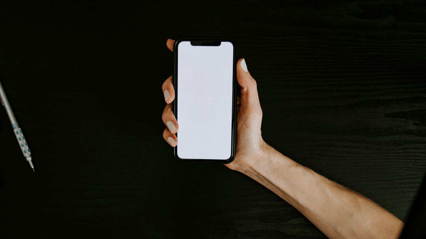 A hand holding a digital device
