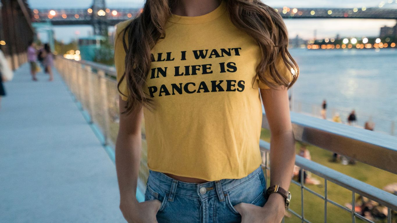 woman in yellow crew-neck t-shirt and blue denim bottoms