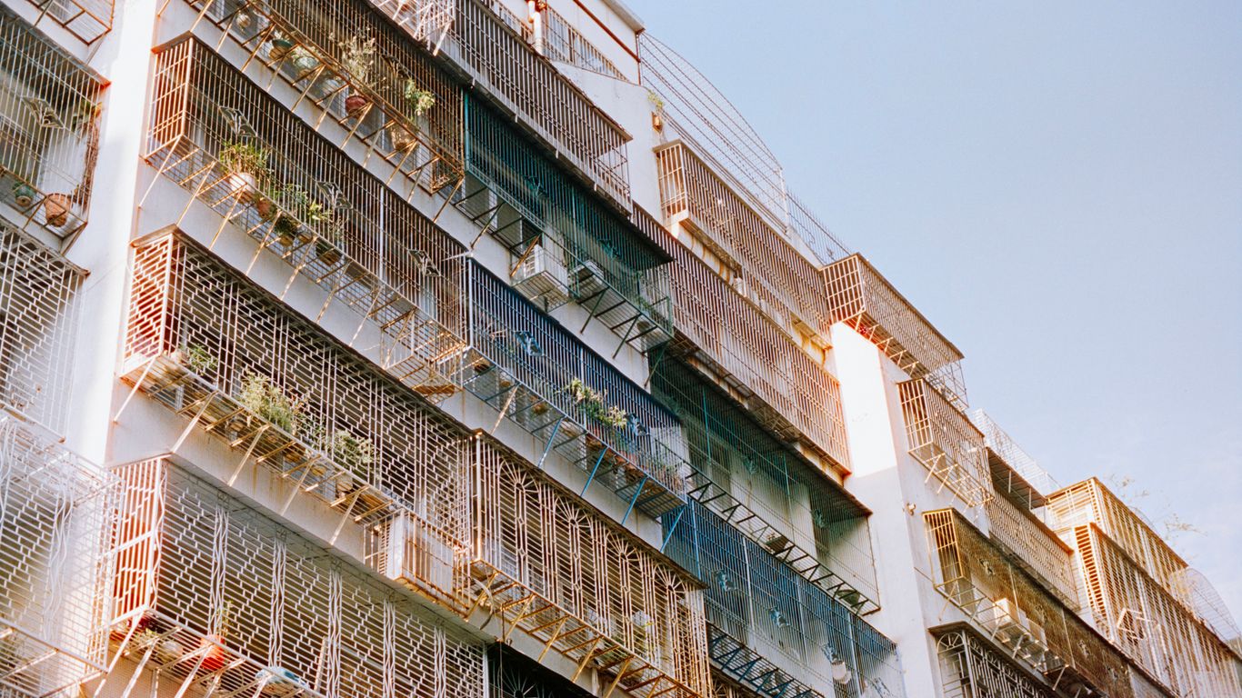 Apartment building balconies with plants and air conditioners
