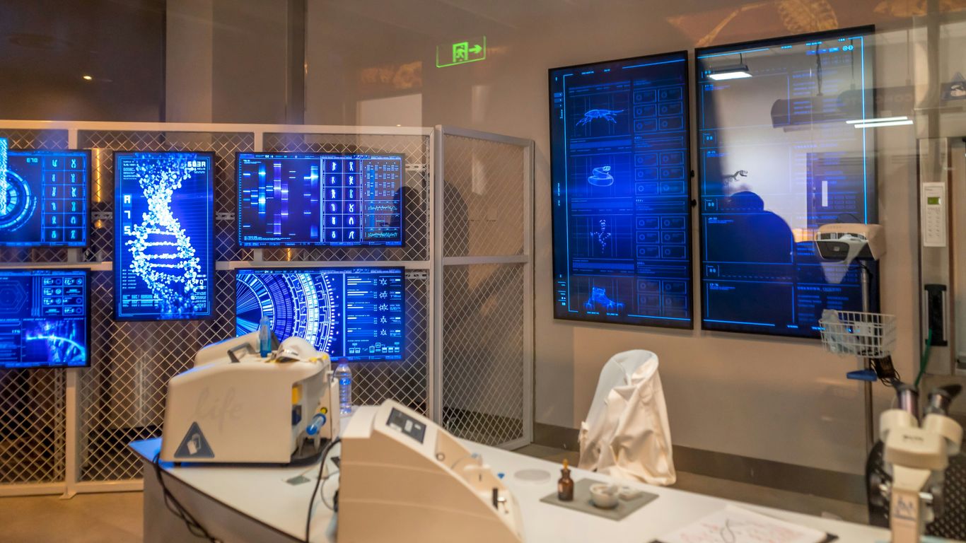 a room with a lot of monitors on the wall