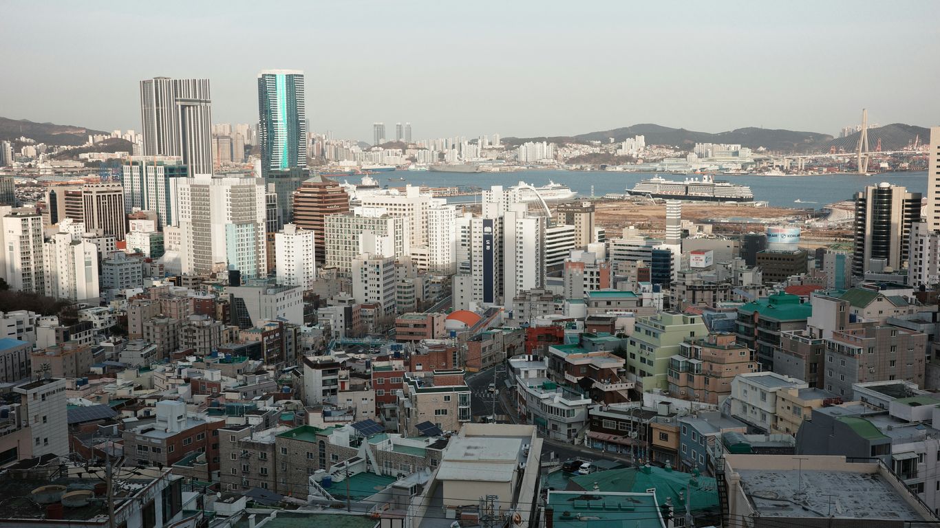 Dense cityscape with distant harbor and hills