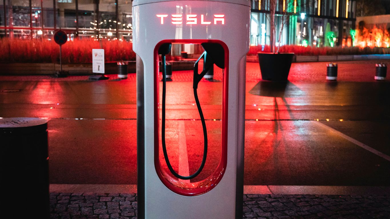 a phone booth sitting on the side of a road
