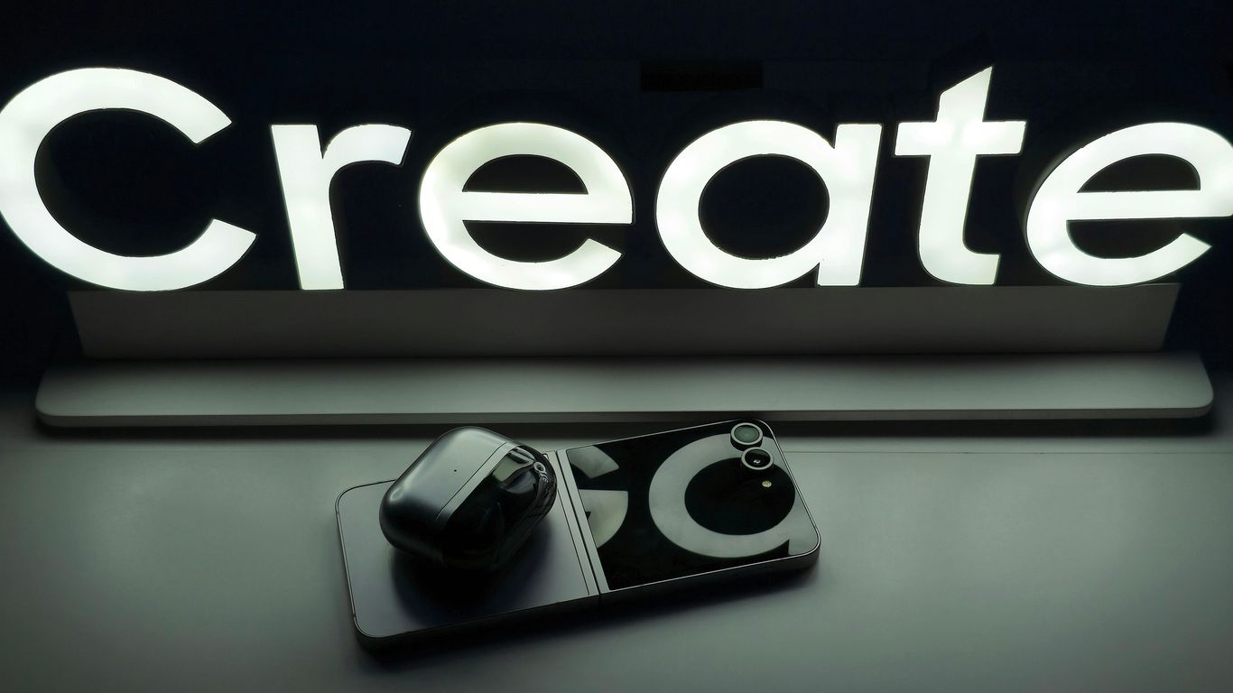 A black and white photo of a camera and a sign