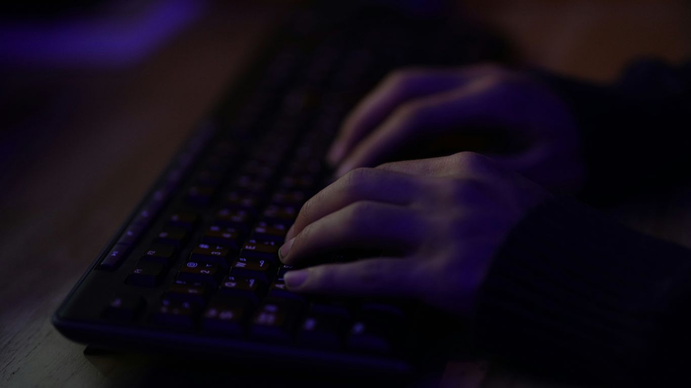 persons hand on black computer keyboard