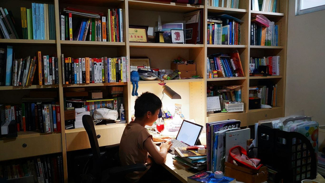 woman in black shirt sitting on chair in front of table