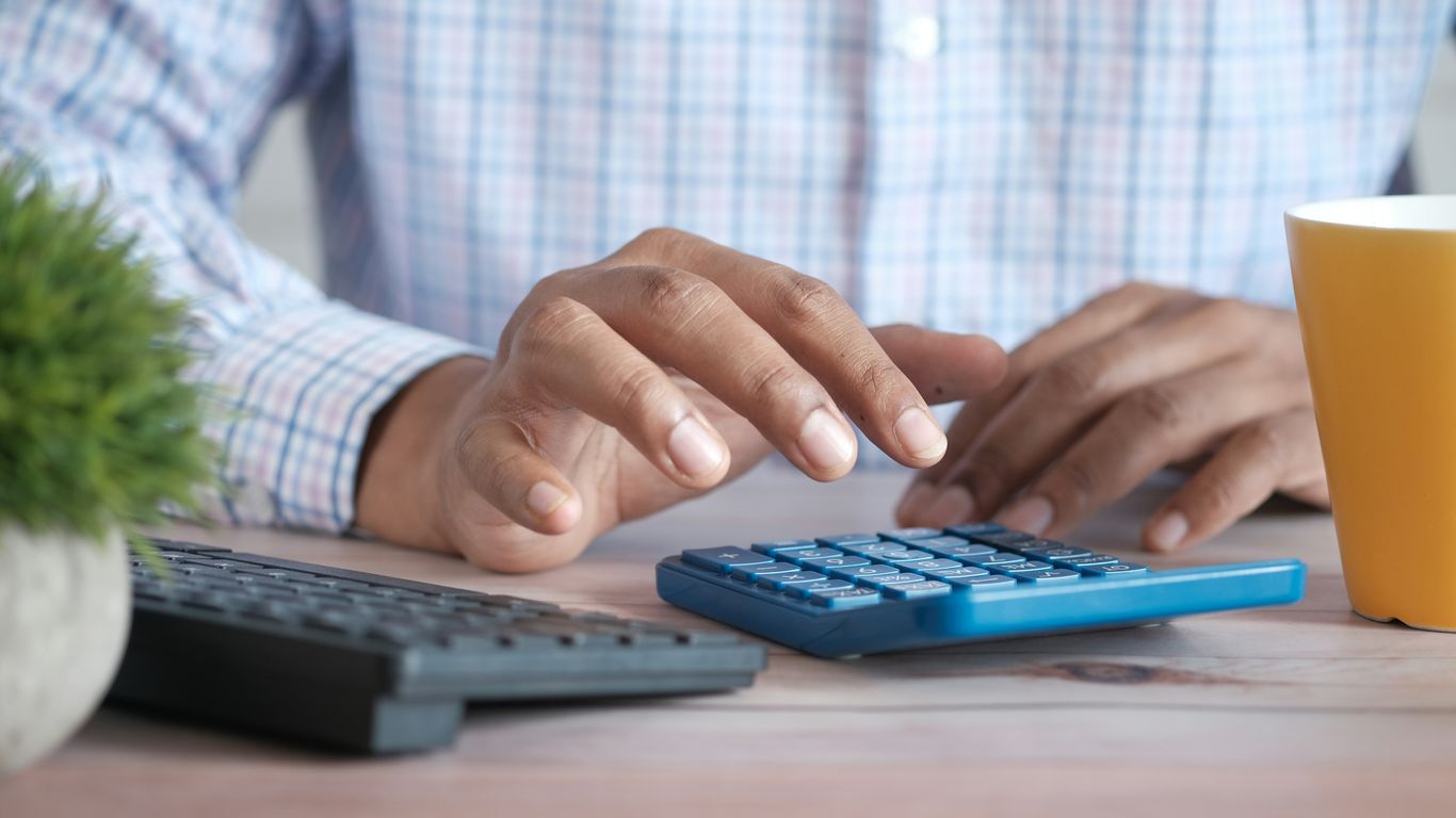 Calculator and commercial invoice on desk