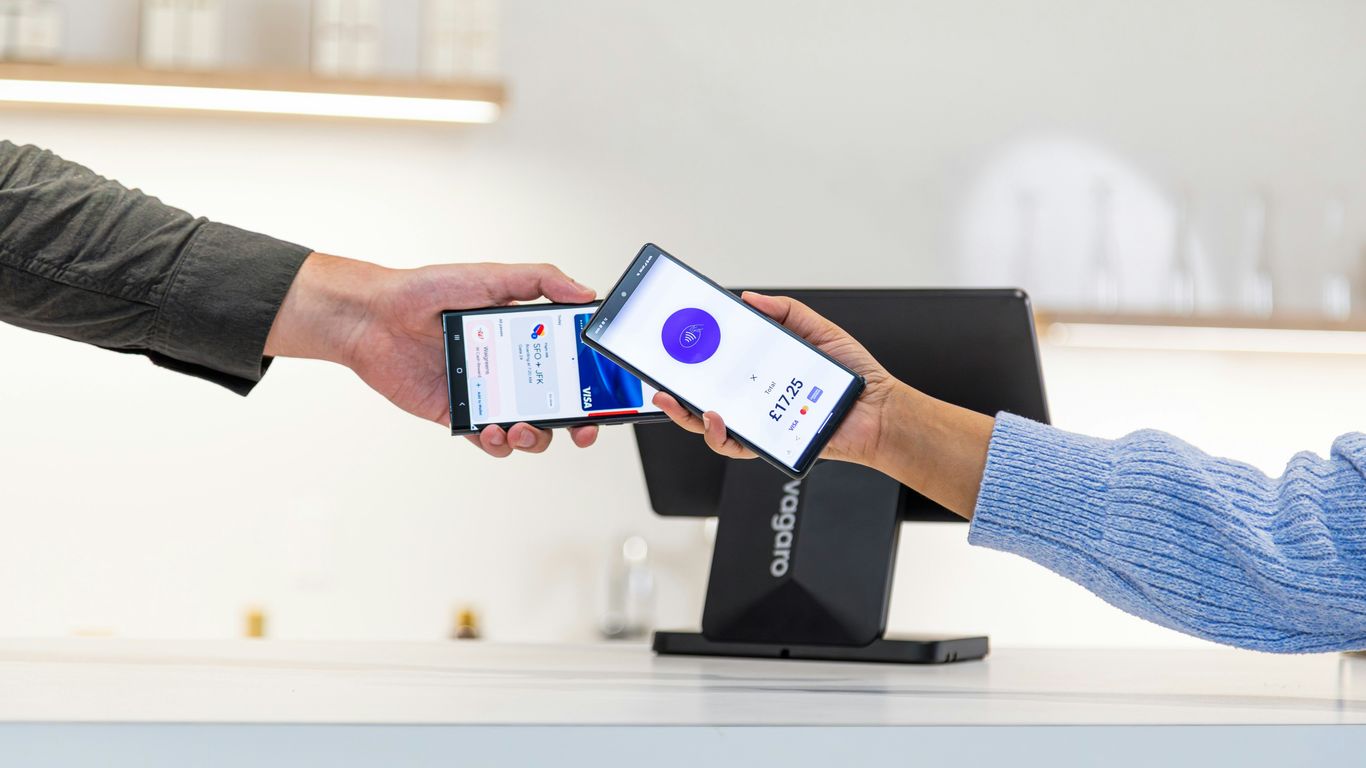 Customer paying with smartphone at point of sale terminal.