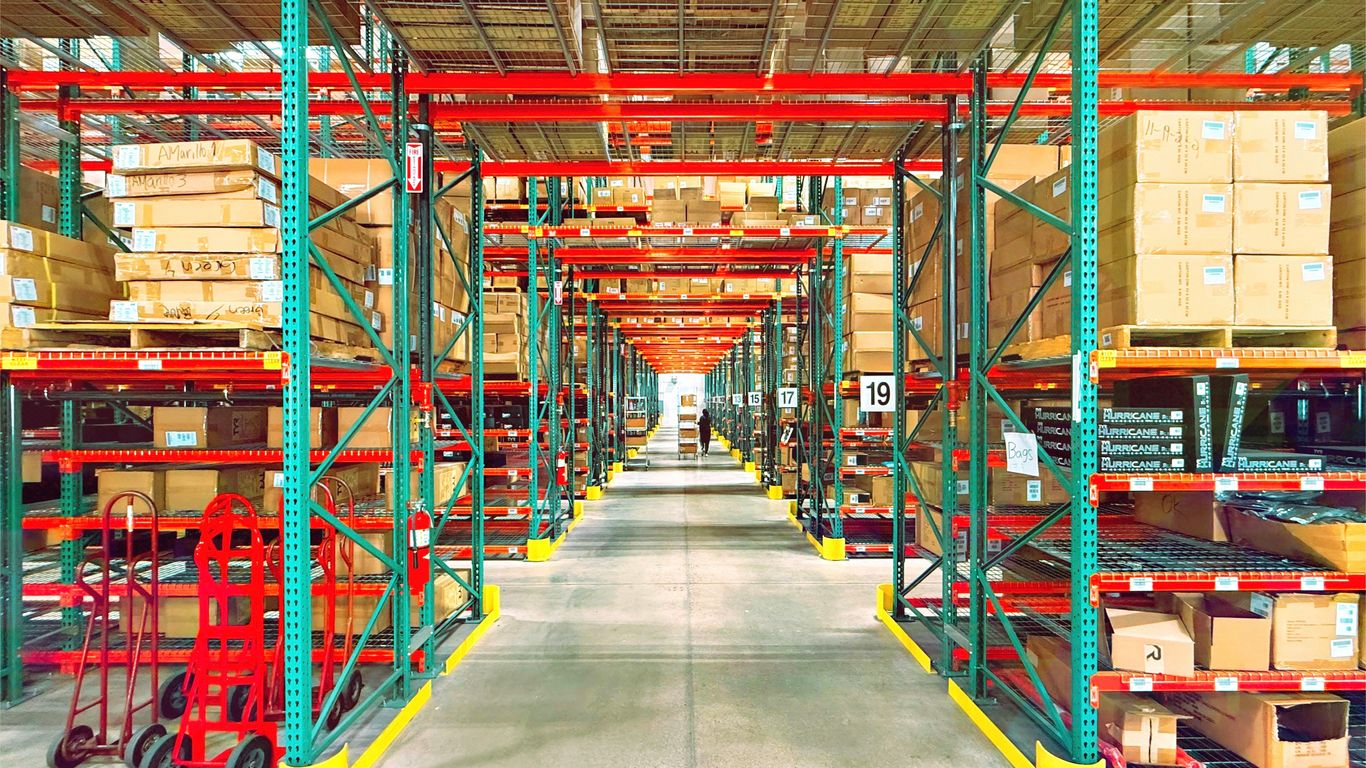 Logistics warehouse managing autonomous fleet with digital tracking screens