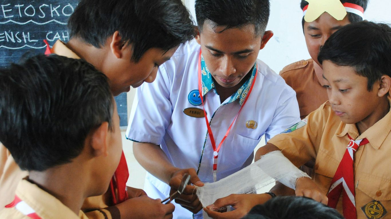 man in white button up shirt holding white smartphone
