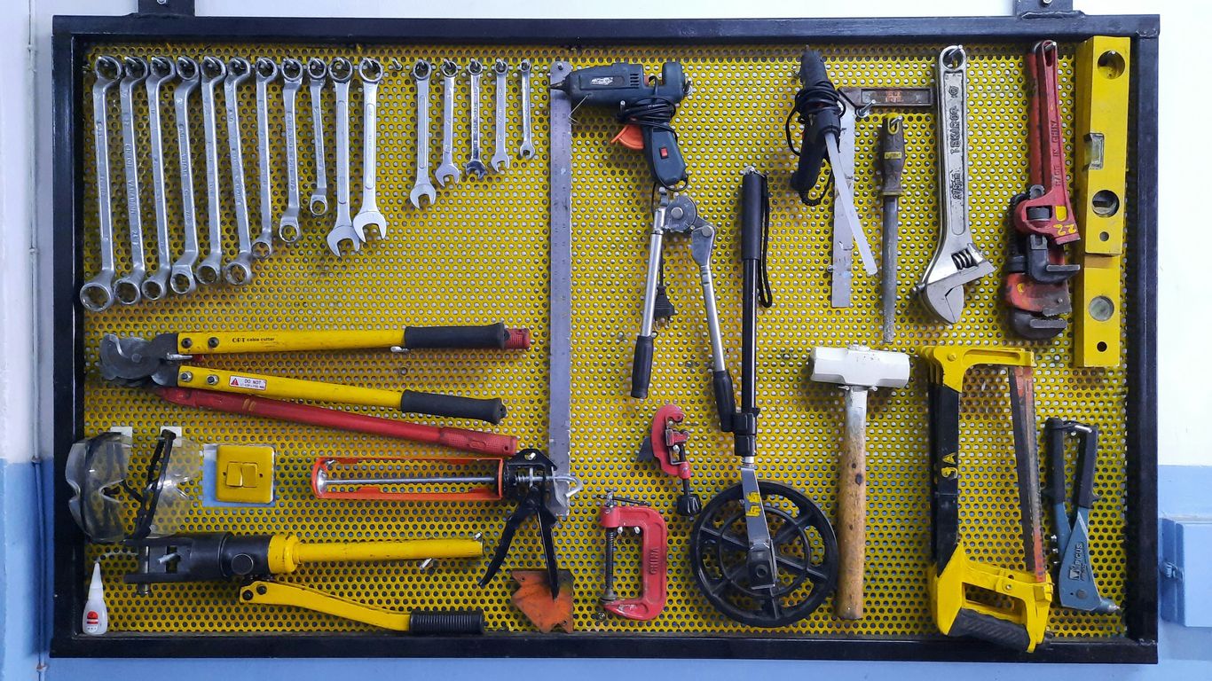 assorted hand tools on brown floor